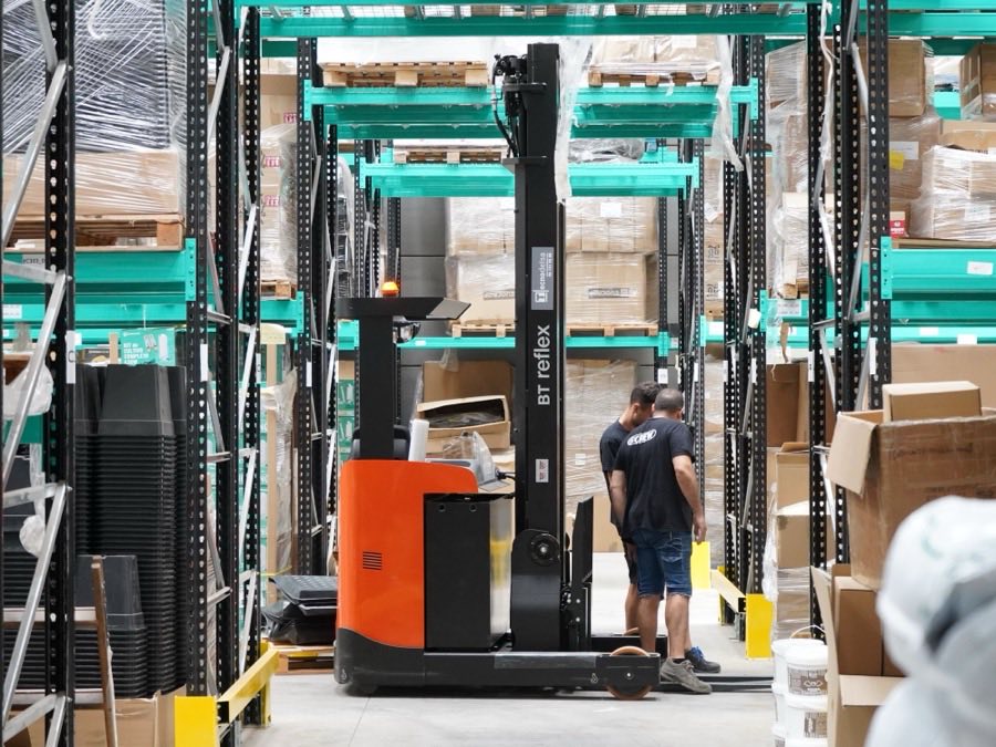 Palletised and wrapped cartons on racking in a despatch warehouse